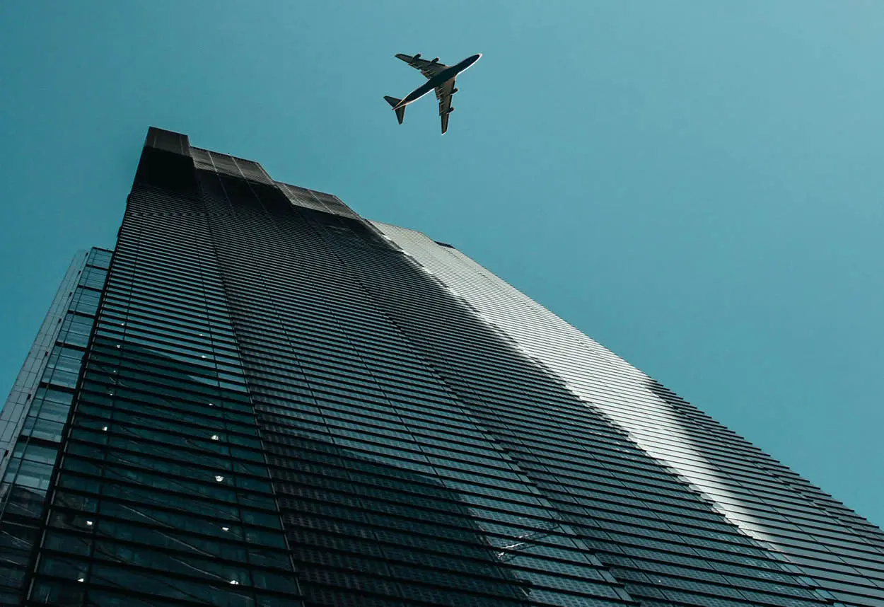 airplane over city buildings