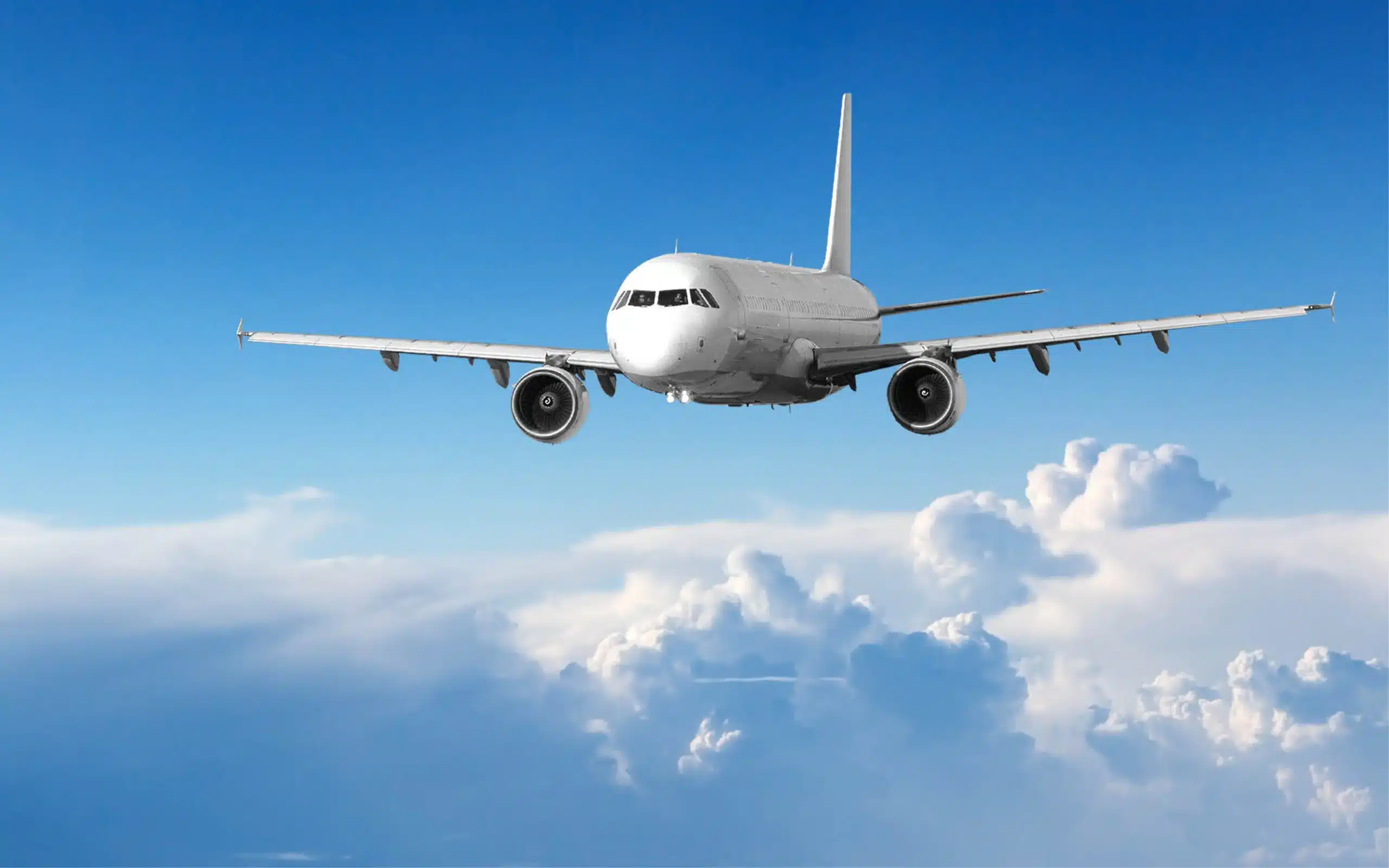 airplane flying through blue sky